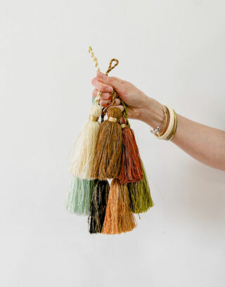 Pompons en laine de plusieurs couleurs tenus par une main