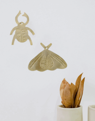 Notre duo d'insecte en laiton martelé accroché au mur