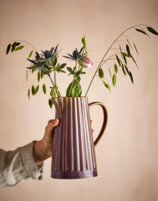 Pichet violet avec des fleurs dedans